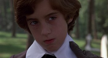 Movie still from “Daisy Miller” (1974), directed by Peter Bogdanovich – A person wearing a shirt and tie; Close Up shot, Over the shoulder angle