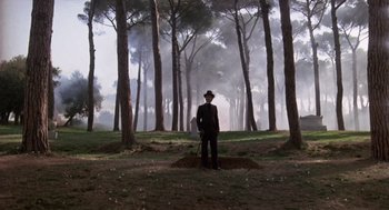 Movie still from “Daisy Miller” (1974), directed by Peter Bogdanovich – A man standing in the middle of a forest; Wide shot, Low angle