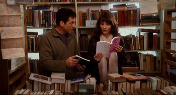 Movie still from “Dan in Real Life” (2007), directed by Peter Hedges – A man and a woman looking at books in a library; Medium shot, Over the shoulder angle