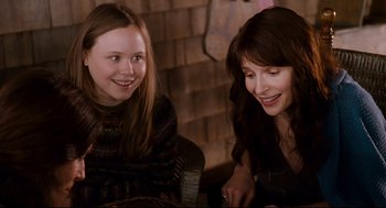 Movie still from “Dan in Real Life” (2007), directed by Peter Hedges – Two young women sitting next to each other smiling; Close Up shot, Over the shoulder angle