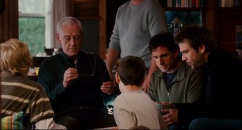 Movie still from “Dan in Real Life” (2007), directed by Peter Hedges – A group of people sitting around a table with a young boy; Medium shot, Over the shoulder angle