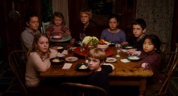 Movie still from “Dan in Real Life” (2007), directed by Peter Hedges – A group of children sitting at a dinner table; Medium shot, High angle