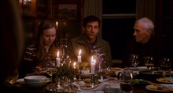Movie still from “Dan in Real Life” (2007), directed by Peter Hedges – A man and a woman sitting at a dinner table with lit candles; Medium shot, Over the shoulder angle