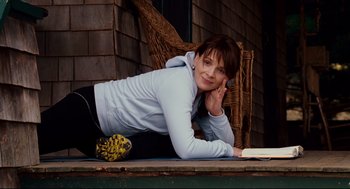 Movie still from “Dan in Real Life” (2007), directed by Peter Hedges – A woman laying on the ground reading a book; Medium shot, Low angle