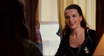 Movie still from “Dan in Real Life” (2007), directed by Peter Hedges – A woman smiling at the camera in front of a window; Close Up shot, Over the shoulder angle