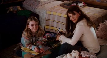 Movie still from “Dan in Real Life” (2007), directed by Peter Hedges – A woman and a girl sitting on the floor; Medium shot, High angle