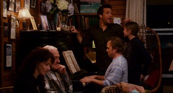 Movie still from “Dan in Real Life” (2007), directed by Peter Hedges – A group of people sitting around a living room; Medium shot, Over the shoulder angle