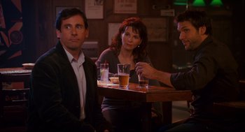 Movie still from “Dan in Real Life” (2007), directed by Peter Hedges – A group of people sitting at a table with drinks in front of them; Medium shot, Over the shoulder angle