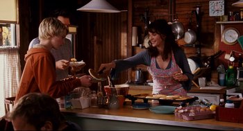 Movie still from “Dan in Real Life” (2007), directed by Peter Hedges – A group of people standing around a counter; Medium shot, Over the shoulder angle