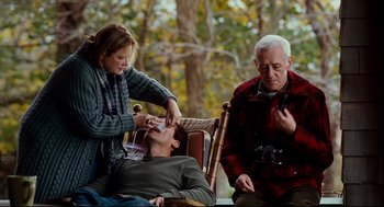 Movie still from “Dan in Real Life” (2007), directed by Peter Hedges – A man sitting in a chair with a woman and another man; Medium shot, Over the shoulder angle