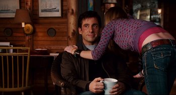 Movie still from “Dan in Real Life” (2007), directed by Peter Hedges – A man sitting in a chair with a woman holding a coffee mug; Medium shot, Over the shoulder angle