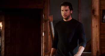 Movie still from “Dan in Real Life” (2007), directed by Peter Hedges – A man in a black shirt is standing in a room; Medium shot, Low angle