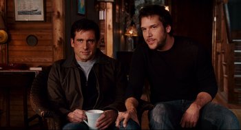 Movie still from “Dan in Real Life” (2007), directed by Peter Hedges – A couple of men sitting next to each other holding a cup; Medium shot, Over the shoulder angle