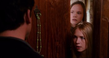 Movie still from “Dan in Real Life” (2007), directed by Peter Hedges – Two young girls looking at each other through a door; Close Up shot, Over the shoulder angle