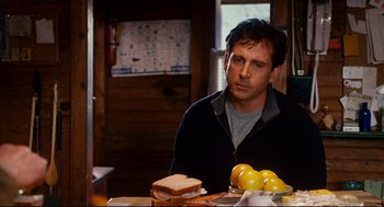 Movie still from “Dan in Real Life” (2007), directed by Peter Hedges – A man sitting in front of a plate of food; Medium shot, Over the shoulder angle