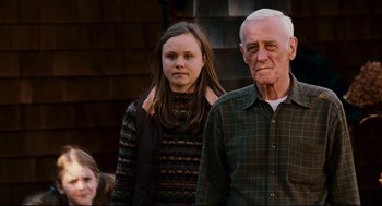 Movie still from “Dan in Real Life” (2007), directed by Peter Hedges – An older man and a young girl standing next to each other; Medium shot, Low angle