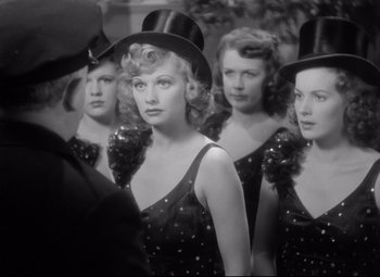 Movie still from “Dance, Girl, Dance” (1940), directed by Roy Del Ruth – A black and white photo of a group of women wearing hats; Close Up shot, Over the shoulder angle