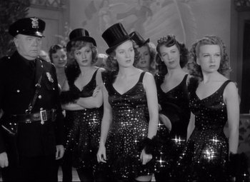 Movie still from “Dance, Girl, Dance” (1940), directed by Roy Del Ruth – A black and white photo of a group of women in sequined dresses; Medium shot, Low angle