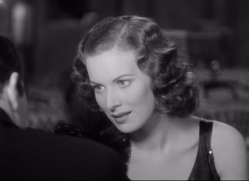 Movie still from “Dance, Girl, Dance” (1940), directed by Roy Del Ruth – A black and white photo of a woman with a black dress; Close Up shot, Over the shoulder angle