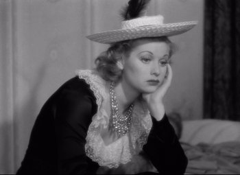 Movie still from “Dance, Girl, Dance” (1940), directed by Roy Del Ruth – A black and white photo of a woman with a hat on her head; Close Up shot, High angle