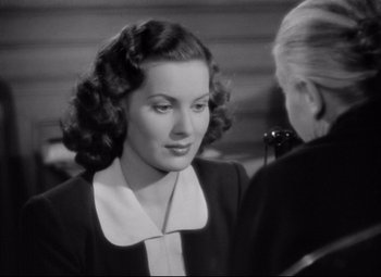 Movie still from “Dance, Girl, Dance” (1940), directed by Roy Del Ruth – An old photo of a woman talking to another woman; Close Up shot, Over the shoulder angle