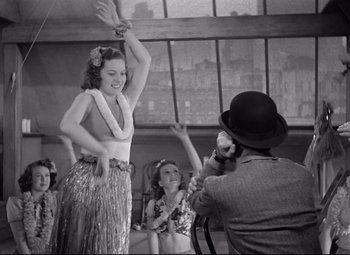 Movie still from “Dance, Girl, Dance” (1940), directed by Roy Del Ruth – An old photo of a man and a woman dancing; Medium shot, Low angle