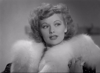 Movie still from “Dance, Girl, Dance” (1940), directed by Roy Del Ruth – An old black and white photo of a woman in a fur coat; Close Up shot, Low angle