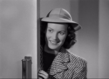 Movie still from “Dance, Girl, Dance” (1940), directed by Roy Del Ruth – A black and white photo of a woman wearing a hat; Close Up shot, High angle