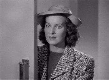 Movie still from “Dance, Girl, Dance” (1940), directed by Roy Del Ruth – A black and white photo of a woman wearing a hat; Close Up shot, Low angle