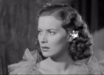 Movie still from “Dance, Girl, Dance” (1940), directed by Roy Del Ruth – A black - and - white photo of a woman with a flower in her hair; Close Up shot, High angle