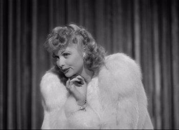 Movie still from “Dance, Girl, Dance” (1940), directed by Roy Del Ruth – A black and white photo of a woman wearing a fur coat; Close Up shot, High angle