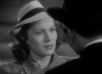 Movie still from “Dance, Girl, Dance” (1940), directed by Roy Del Ruth – A black and white photo of a woman wearing a hat; Close Up shot, Over the shoulder angle