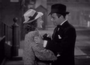 Movie still from “Dance, Girl, Dance” (1940), directed by Roy Del Ruth – A man and a woman are dancing together outside; Medium shot, High angle