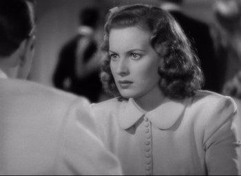 Movie still from “Dance, Girl, Dance” (1940), directed by Roy Del Ruth – A black - and - white photo of a woman in a white dress; Close Up shot, Over the shoulder angle