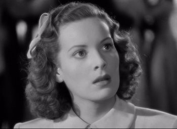 Movie still from “Dance, Girl, Dance” (1940), directed by Roy Del Ruth – A black and white photo of a woman with a bow in her hair; Close Up shot, High angle