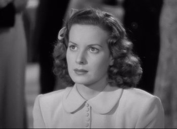 Movie still from “Dance, Girl, Dance” (1940), directed by Roy Del Ruth – A black and white photo of a woman in a white dress; Close Up shot, Low angle