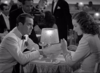 Movie still from “Dance, Girl, Dance” (1940), directed by Roy Del Ruth – A man and a woman sitting at a dinner table; Medium shot, High angle