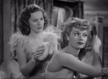 Movie still from “Dance, Girl, Dance” (1940), directed by Roy Del Ruth – Two women in a dressing room looking at each other; Medium shot, Low angle