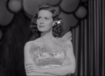 Movie still from “Dance, Girl, Dance” (1940), directed by Roy Del Ruth – A black - and - white photo of a woman in an evening gown; Close Up shot, Low angle