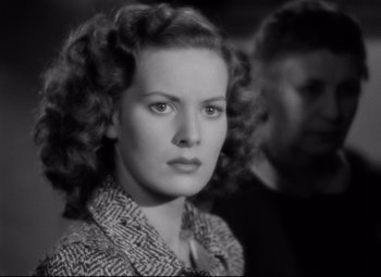 Movie still from “Dance, Girl, Dance” (1940), directed by Roy Del Ruth – An old photo of a woman with curly red hair; Close Up shot, Low angle