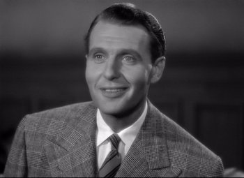 Movie still from “Dance, Girl, Dance” (1940), directed by Roy Del Ruth – An older man in a suit and tie; Close Up shot, Low angle