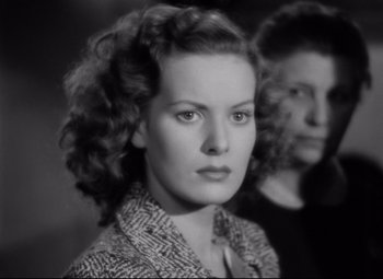 Movie still from “Dance, Girl, Dance” (1940), directed by Roy Del Ruth – A woman in a black and white photo with another woman in a black and white photo; Close Up shot, Low angle
