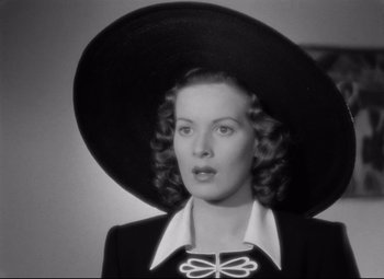 Movie still from “Dance, Girl, Dance” (1940), directed by Roy Del Ruth – A black and white photo of a woman wearing a large hat; Close Up shot, Low angle