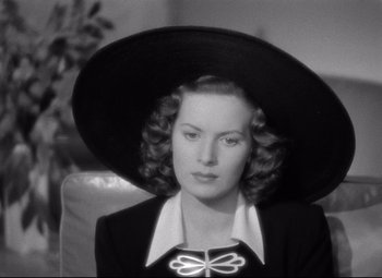 Movie still from “Dance, Girl, Dance” (1940), directed by Roy Del Ruth – A black and white photo of a woman wearing a large hat; Close Up shot, High angle