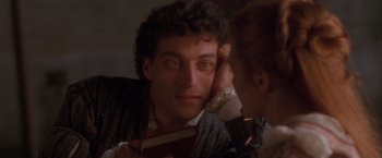 Movie still from “Dangerous Beauty” (1998), directed by Marshall Herskovitz – A man and a woman looking in the same direction in the mirror; Close Up shot, Over the shoulder angle
