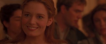 Movie still from “Dangerous Beauty” (1998), directed by Marshall Herskovitz – A woman's face with a man in the background; Close Up shot, Over the shoulder angle