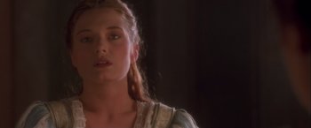 Movie still from “Dangerous Beauty” (1998), directed by Marshall Herskovitz – A woman with long blonde hair wearing a white dress; Close Up shot, Over the shoulder angle