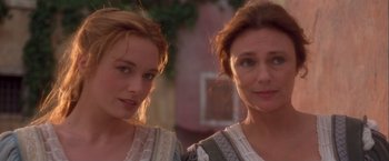 Movie still from “Dangerous Beauty” (1998), directed by Marshall Herskovitz – Two women standing next to each other in front of a building; Close Up shot, Low angle