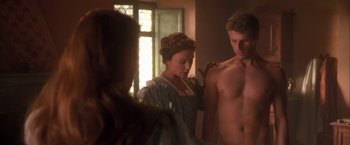 Movie still from “Dangerous Beauty” (1998), directed by Marshall Herskovitz – A man and a woman standing next to each other in front of a mirror; Medium shot, Over the shoulder angle