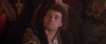 Movie still from “Dangerous Beauty” (1998), directed by Marshall Herskovitz – A person wearing a suit; Close Up shot, Low angle